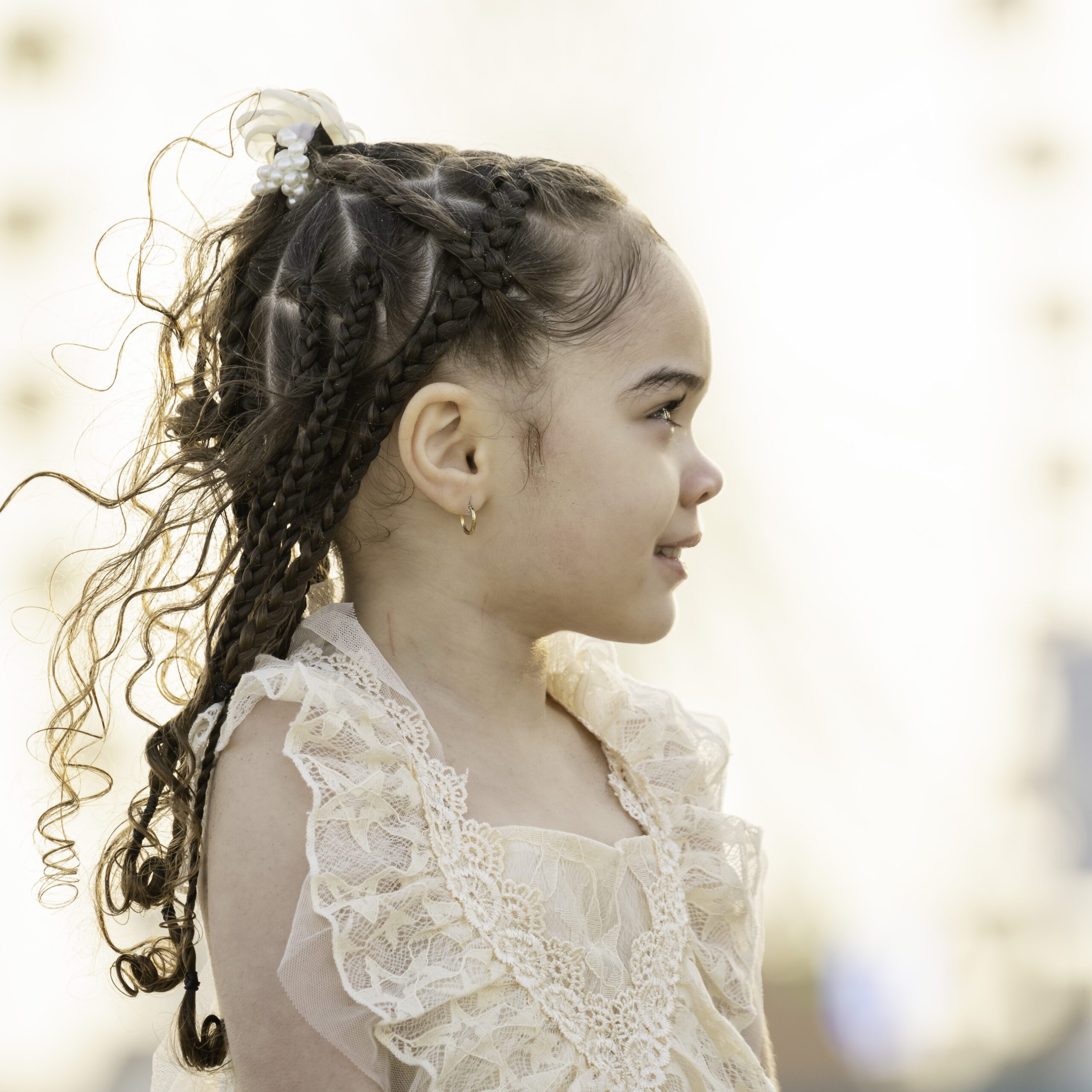 a young girl with long hair wearing a white dress
