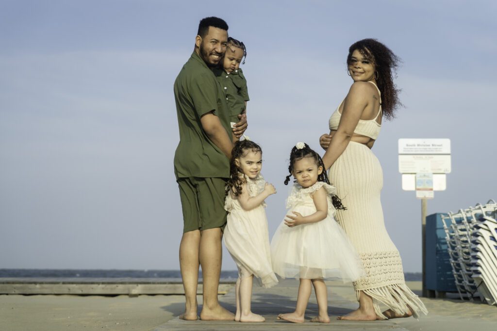a family poses for a photo on the beach