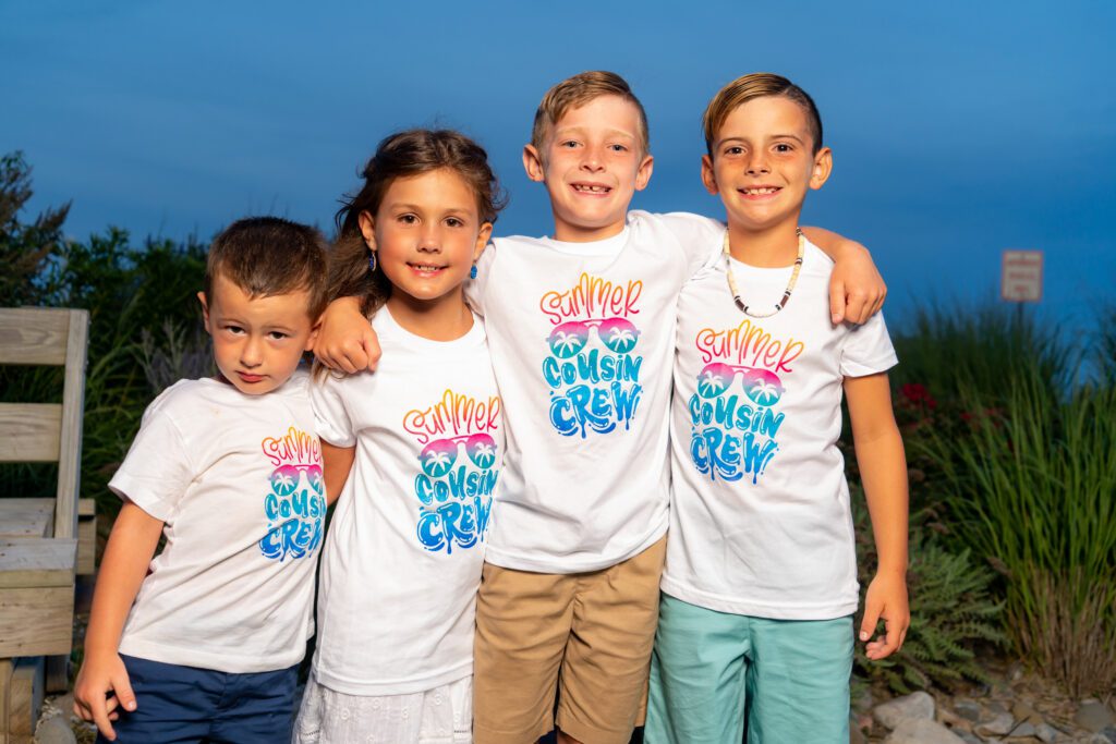 three boys and a girl posing for a picture