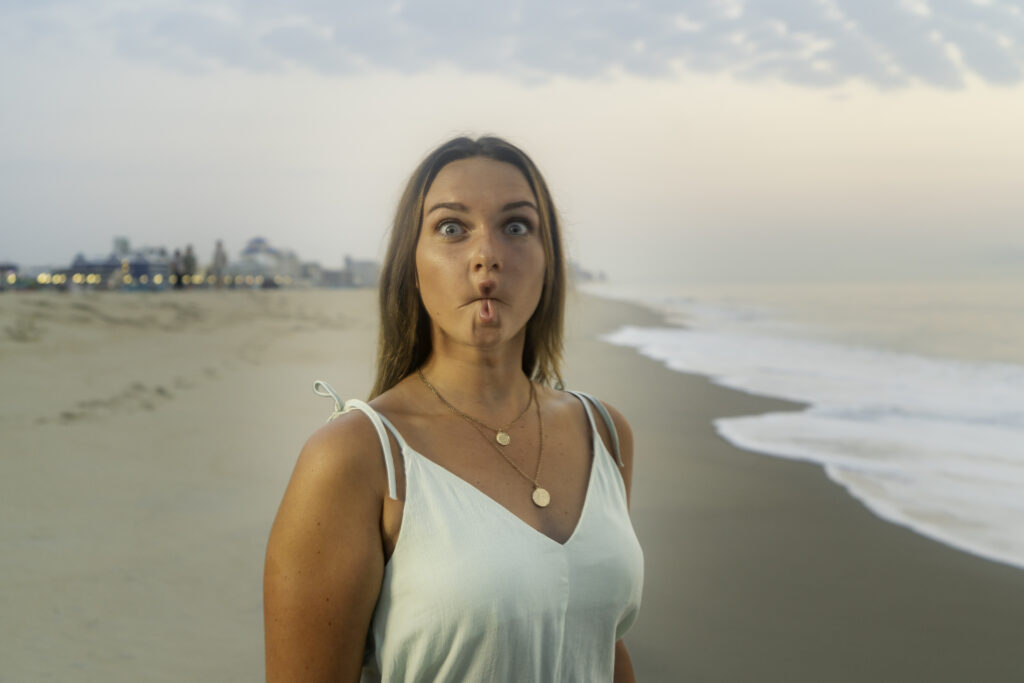 a woman making a funny face on the beach