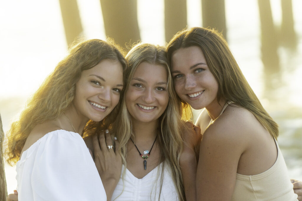 three girls are posing for a picture together