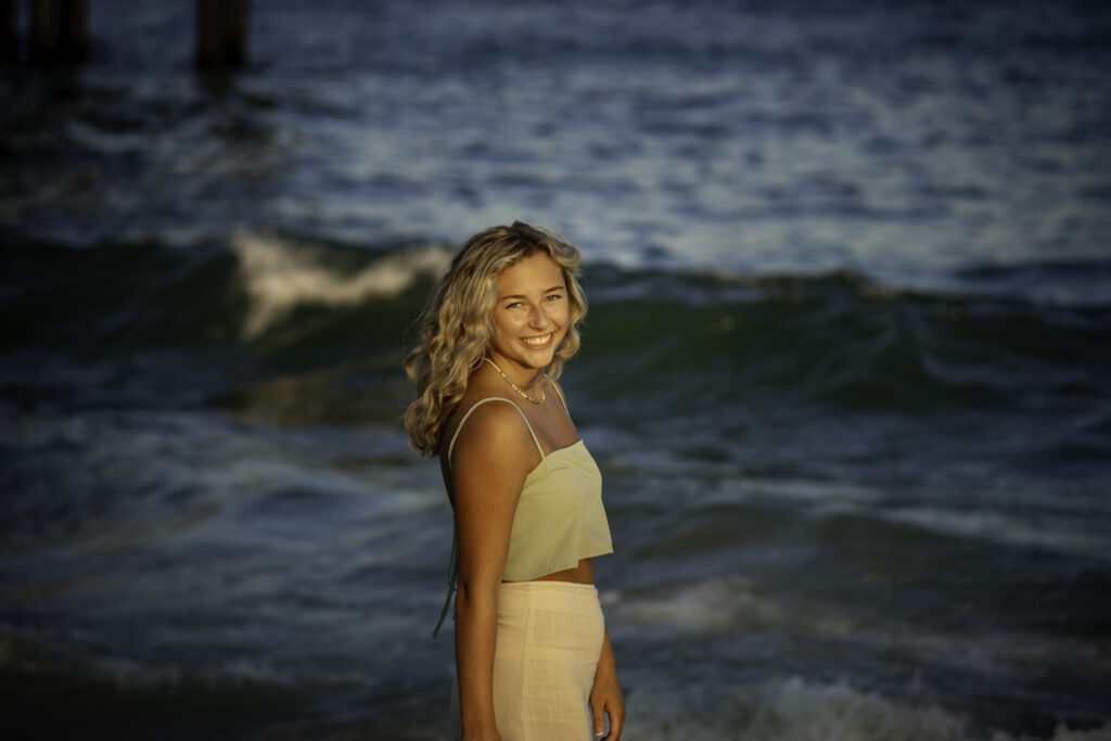 a woman standing in front of the ocean