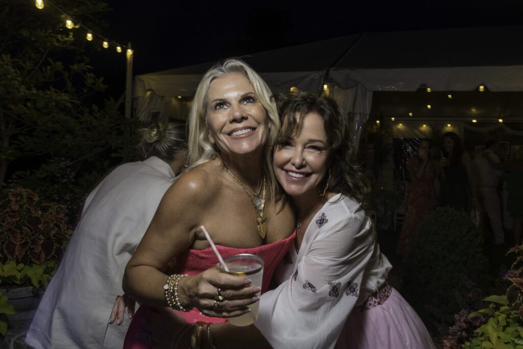 two women hugging each other at a party