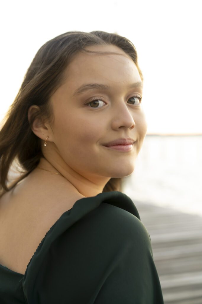 a woman in a green dress is smiling