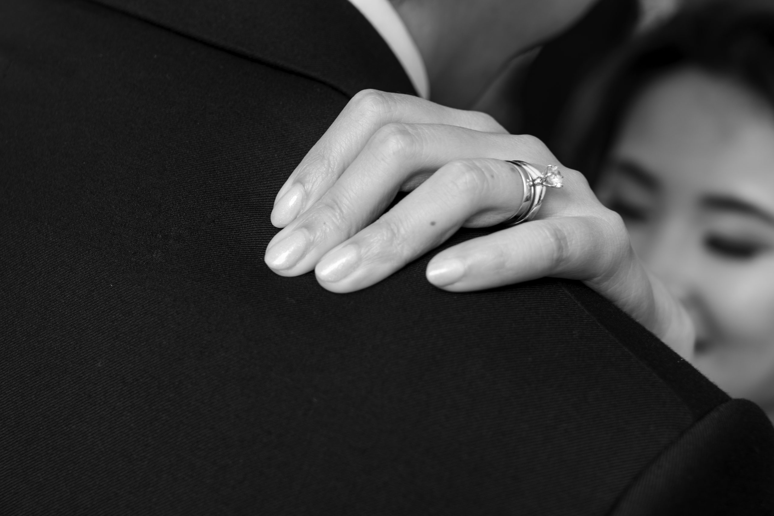 a close up of a person wearing a wedding ring