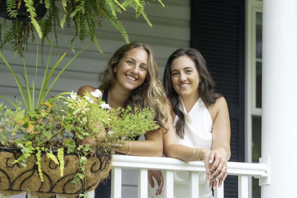 two women sitting on a porch next to each other