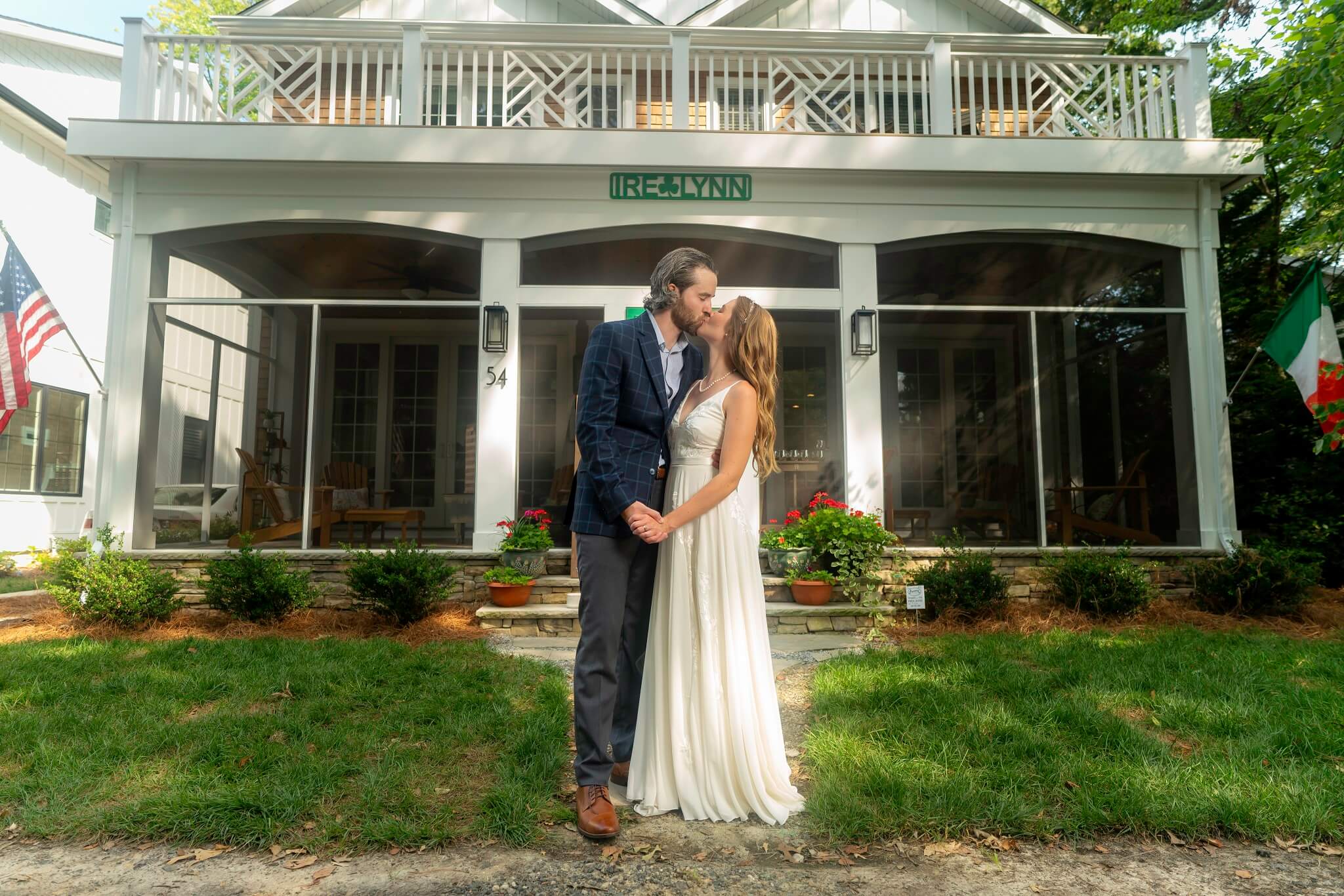 Bride and groom kissing outside their home in a residential neighborhood