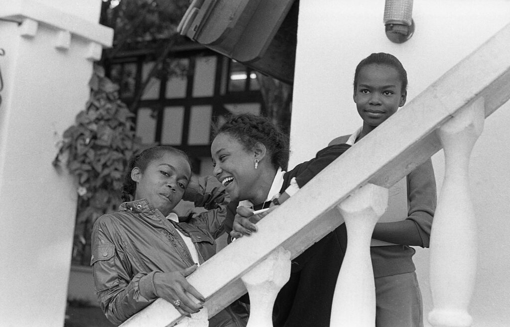 three women are standing on the steps together