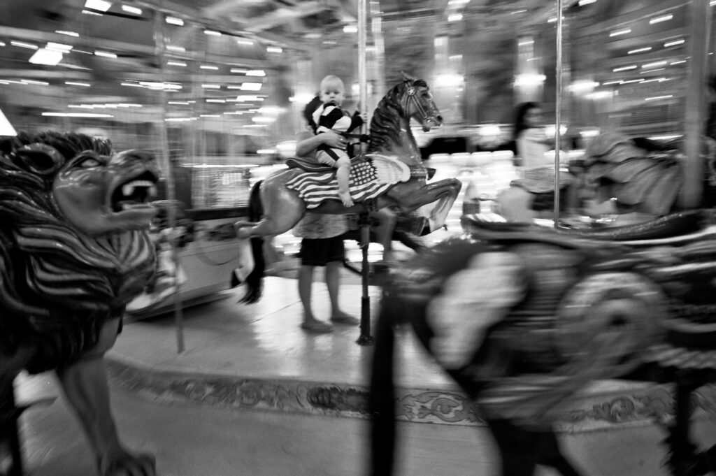 a carousel with horses and people on it