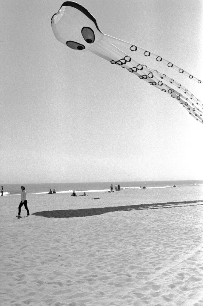 a man is flying a kite on the beach
