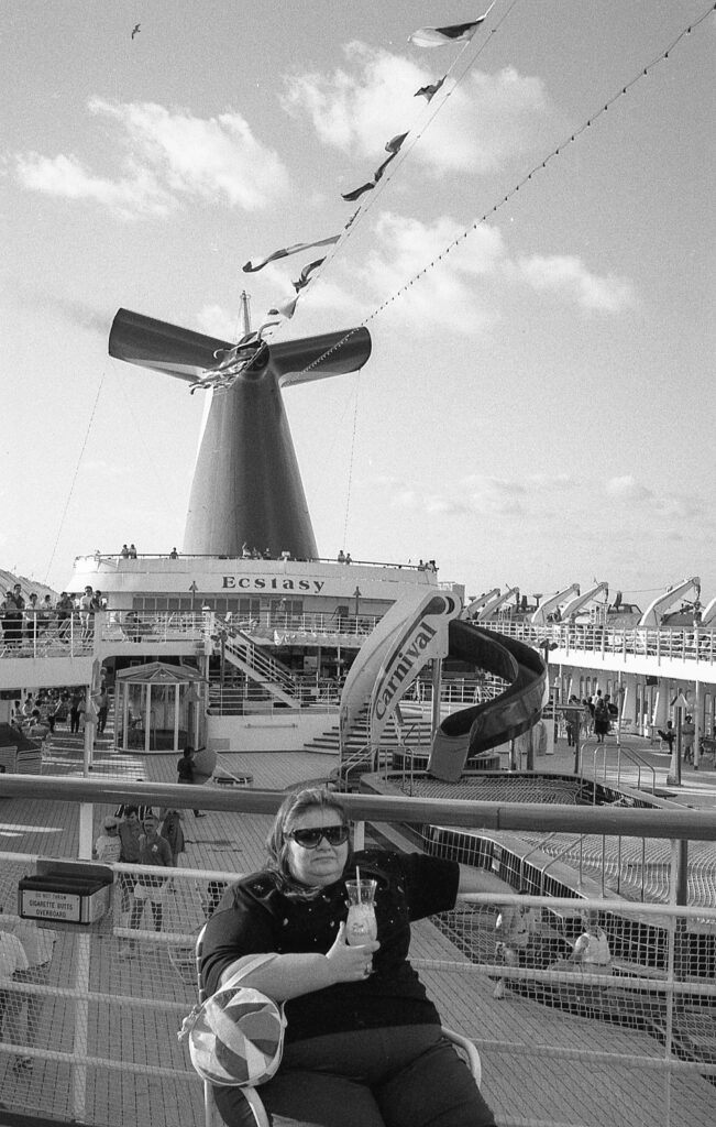 a woman sitting on a bench in front of a windmill