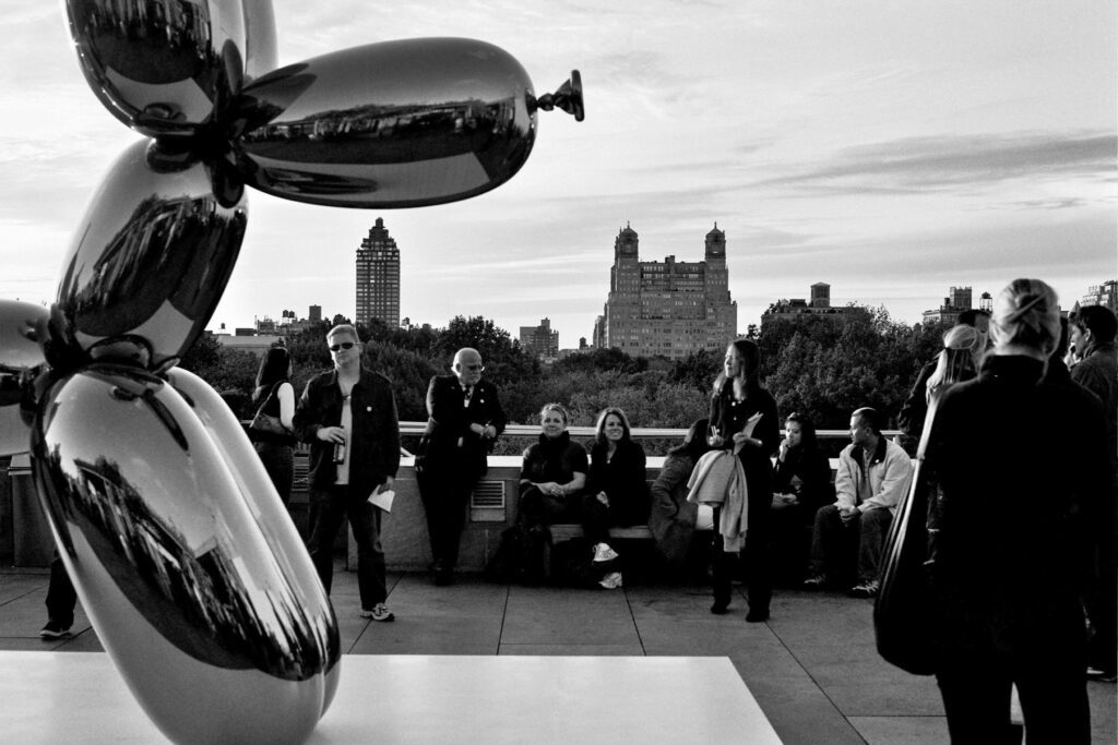 a group of people standing around a sculpture