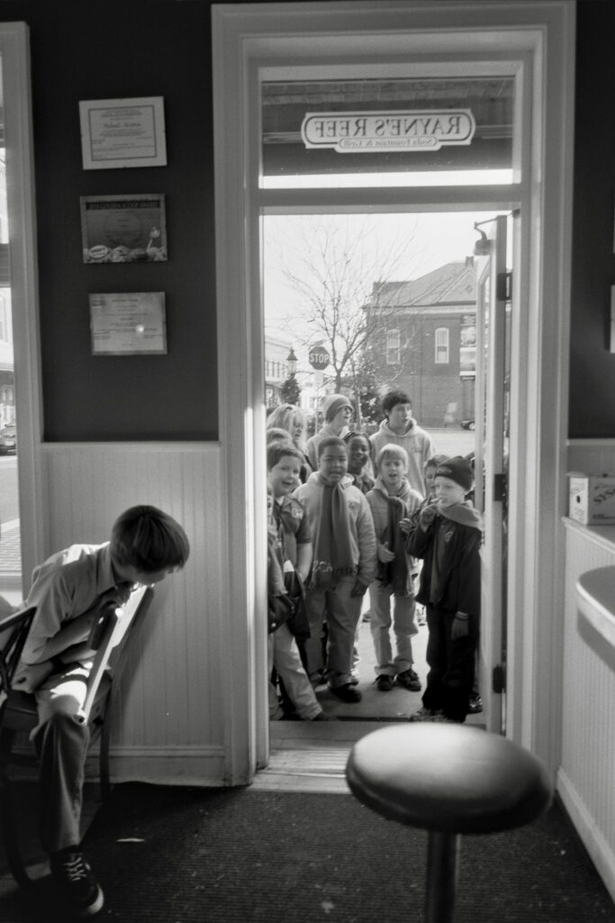 a group of children standing in front of a door