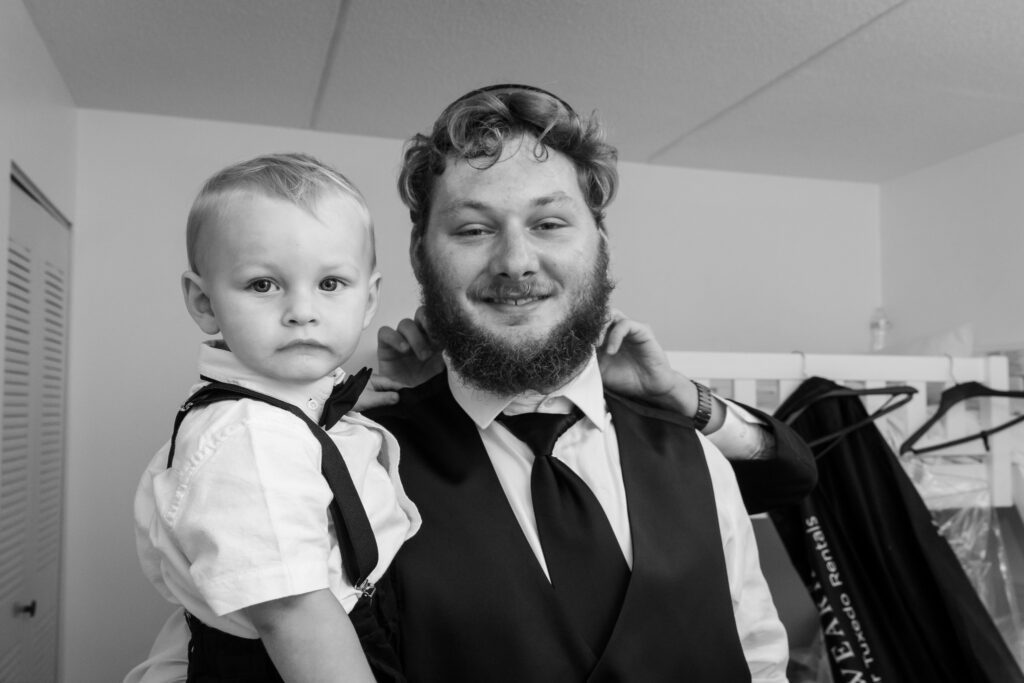 a man with a beard holding a little boy