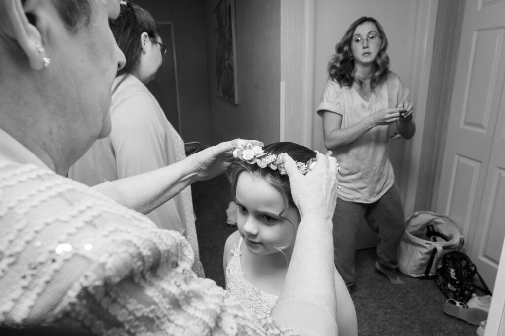 a woman is getting her hair done in the mirror