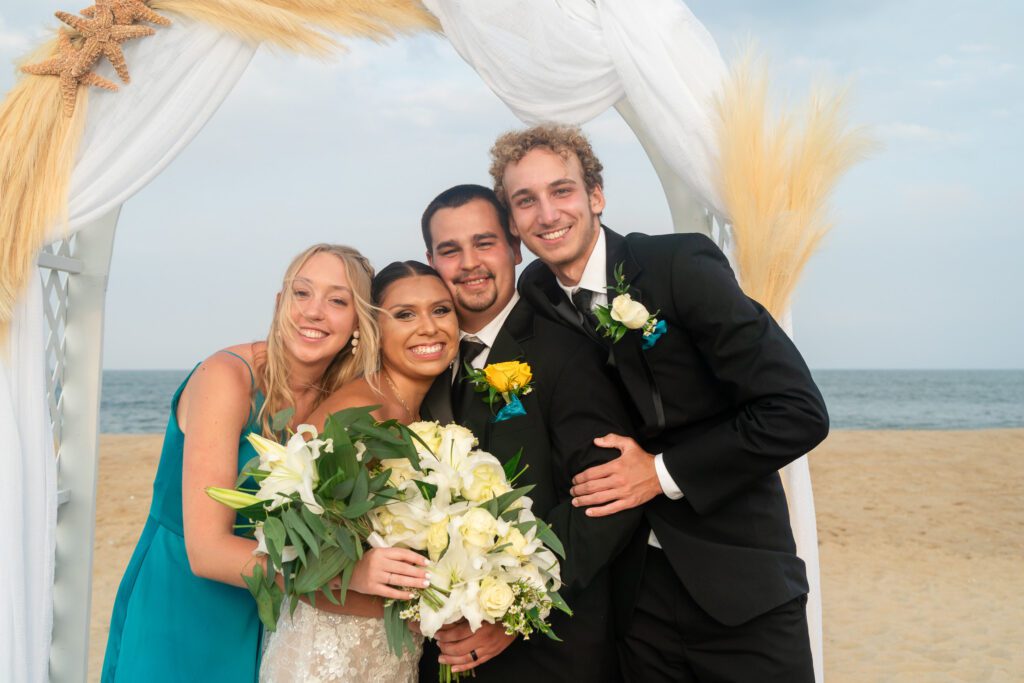 a group of people standing next to each other on a beach