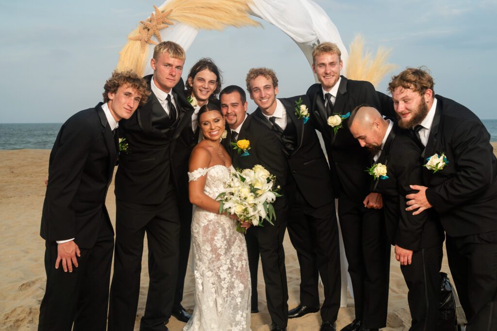 a group of people standing next to each other on a beach