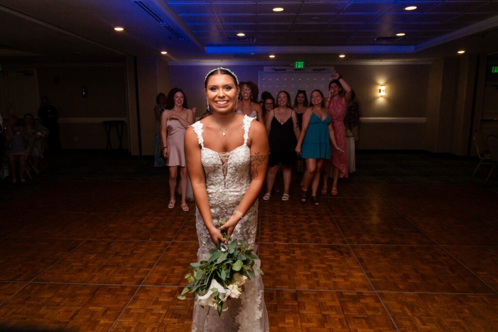 a woman standing on a dance floor holding a bouquet