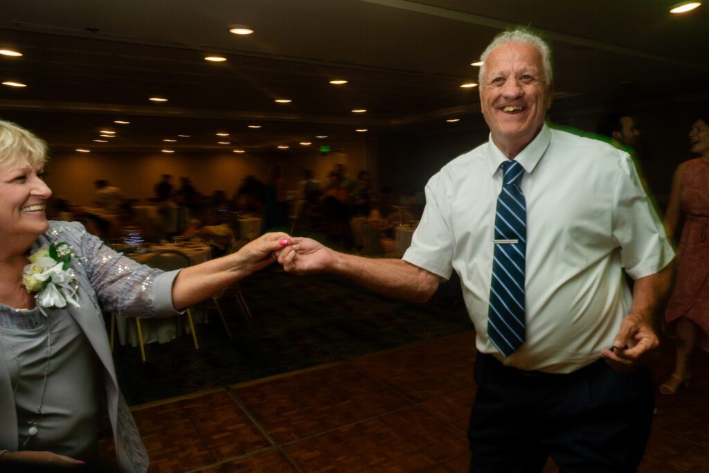 a man and woman dancing together at a party