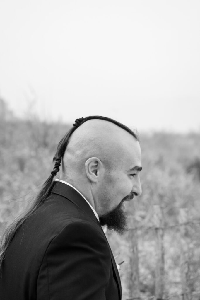 a man with long hair and a beard wearing a suit