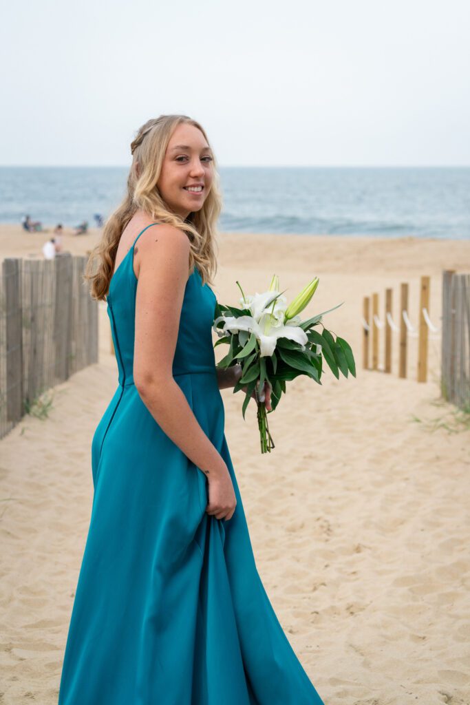 a woman in a blue dress holding a bouquet of flowers