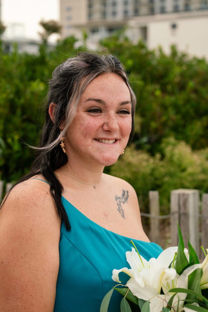 a woman in a blue dress holding a bouquet of flowers