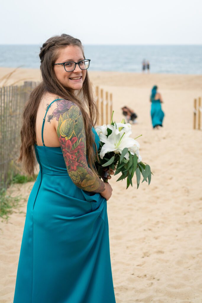 a woman in a blue dress holding a bouquet of flowers