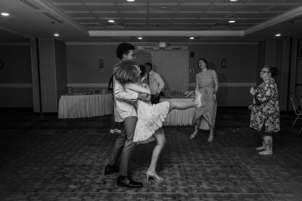 a couple of people that are standing up on a dance floor