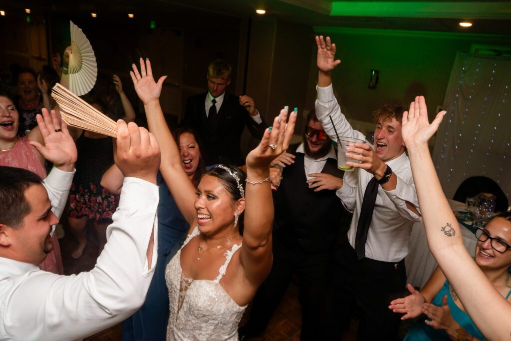 a bride and groom dancing with their guests