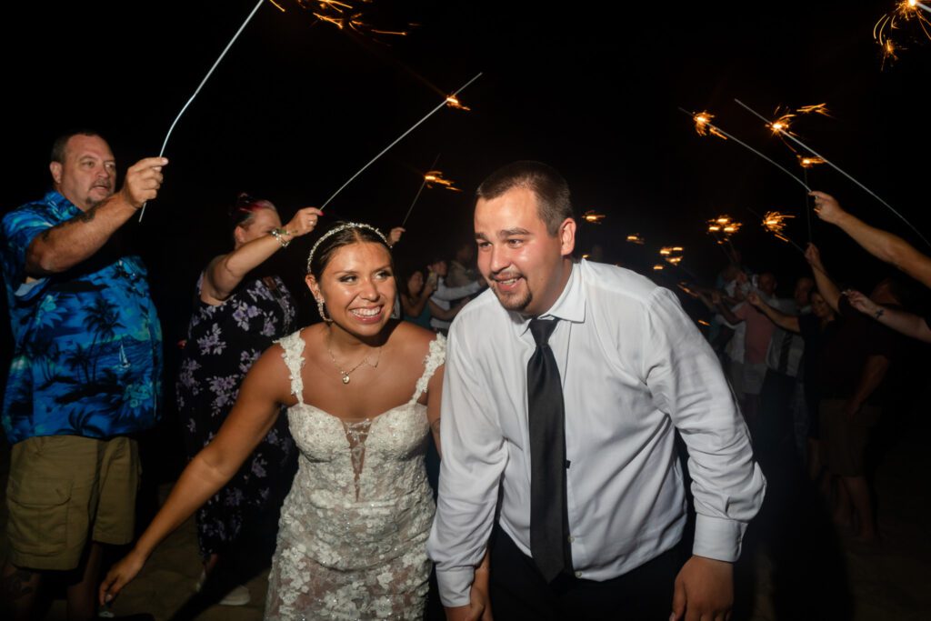 a man and woman holding sparklers in their hands