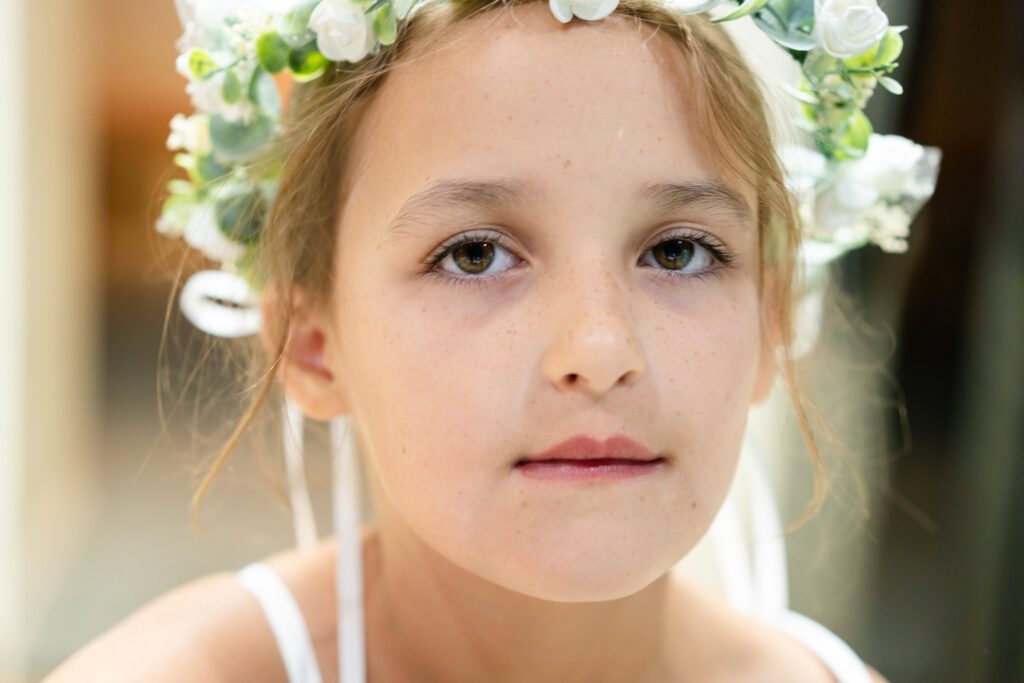 a young girl with a flower crown on her head