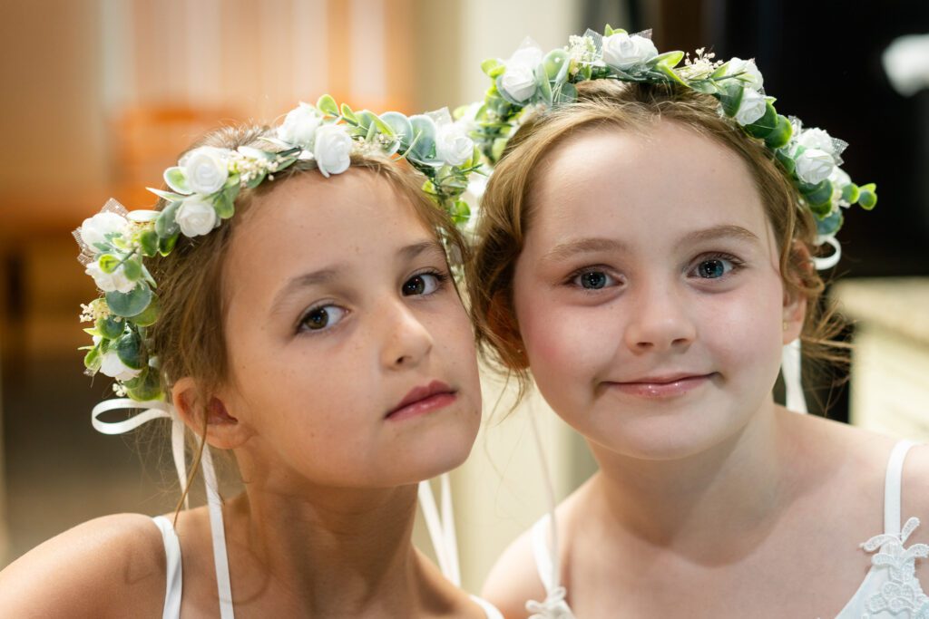 two young girls with flower crowns on their heads