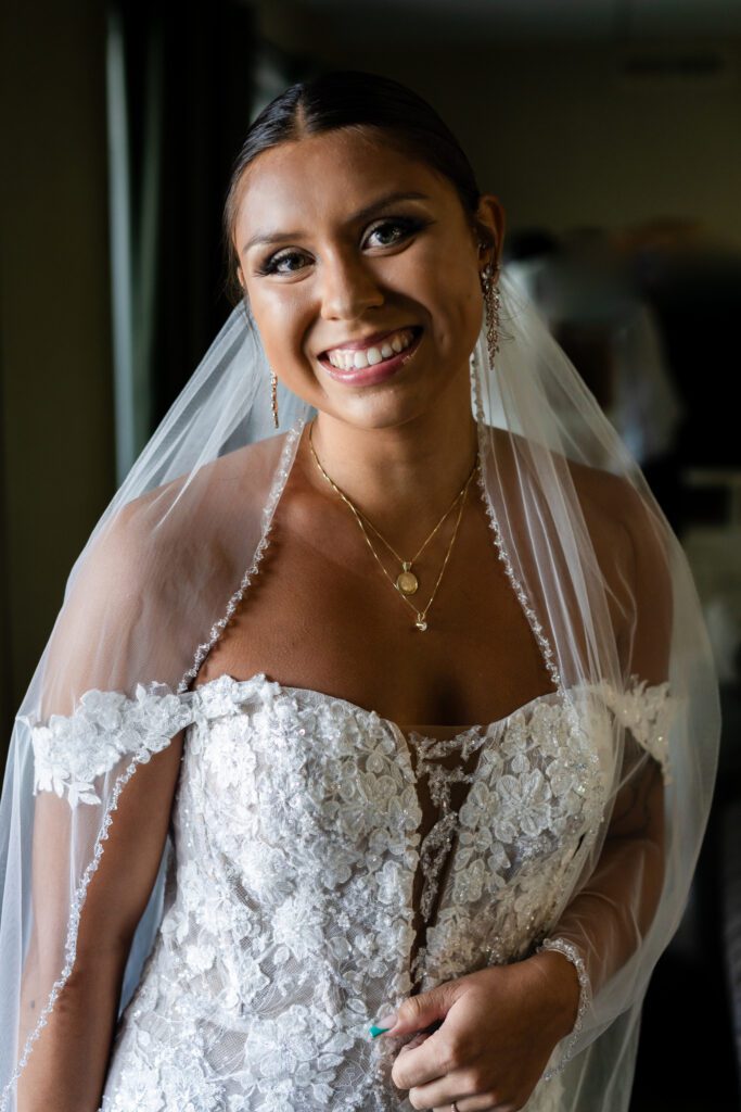 a woman in a wedding dress smiling at the camera