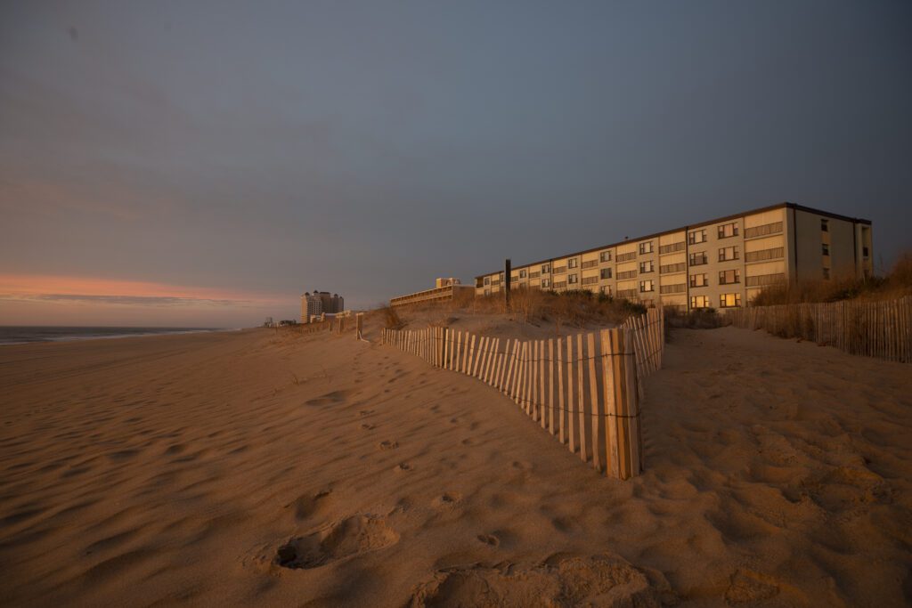 a building on the beach at sunset