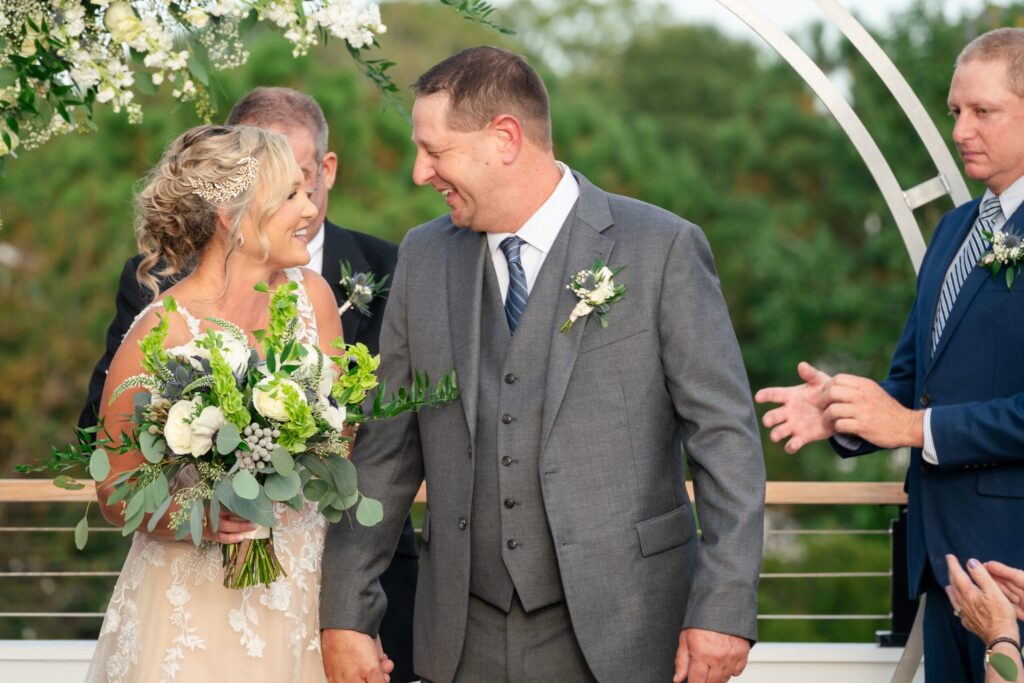 a bride and groom walking down the aisle