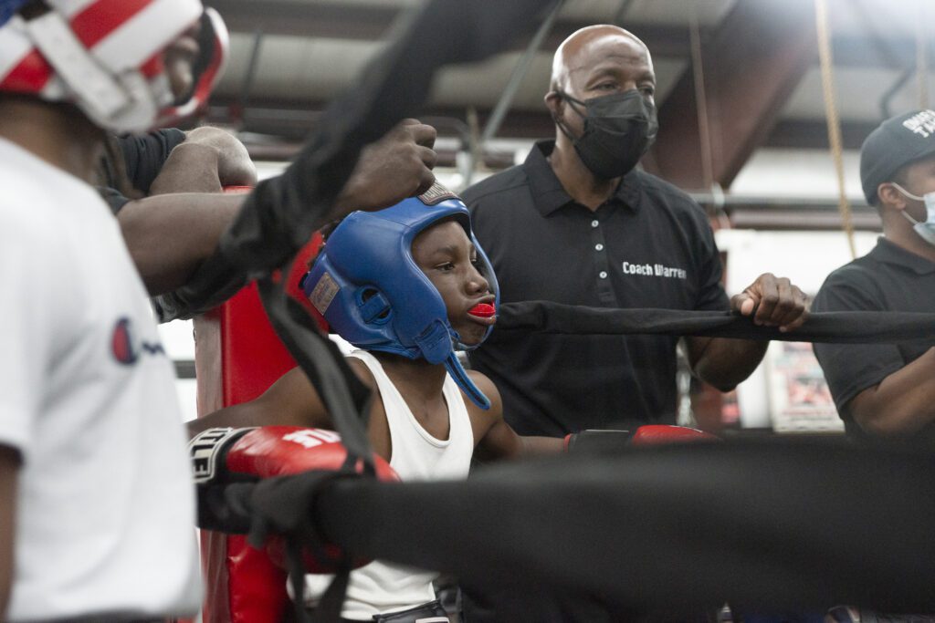 a group of people wearing masks and boxing gloves