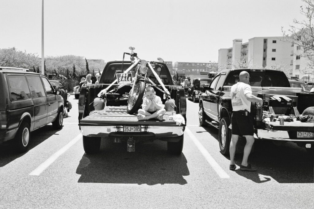 a black and white photo of people in the back of a truck