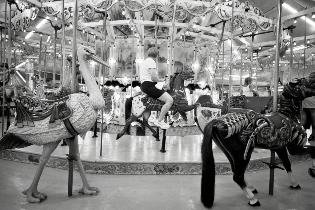 a carousel with horses and people on it