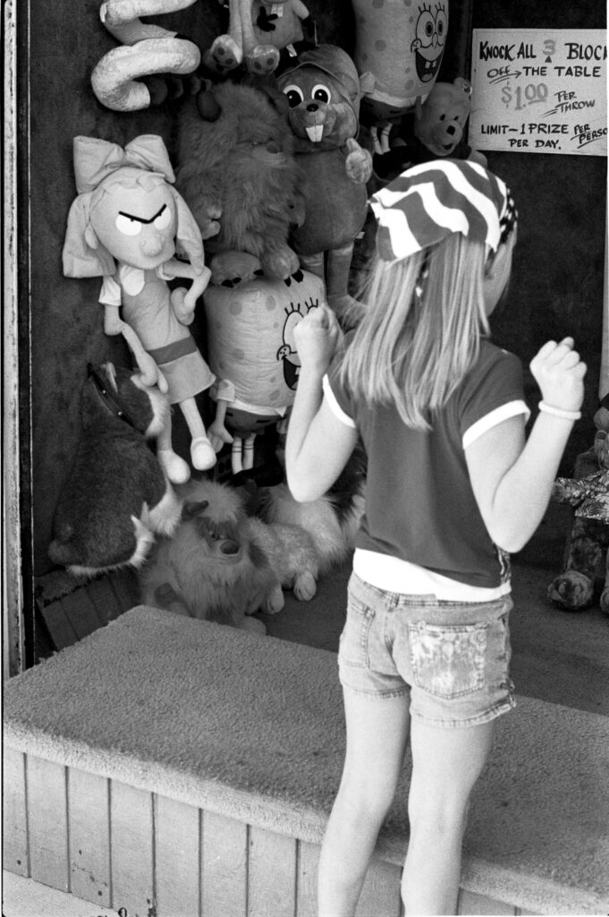 a little girl looking at stuffed animals in a store