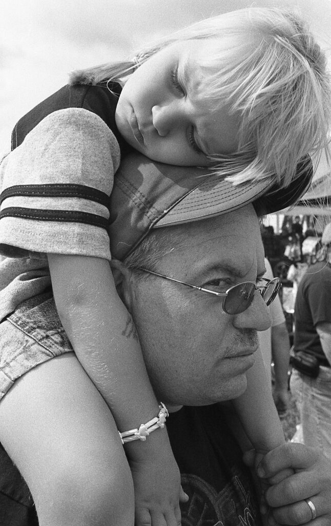 a man holding a small child on his shoulders