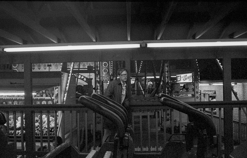 a man standing on top of an escalator
