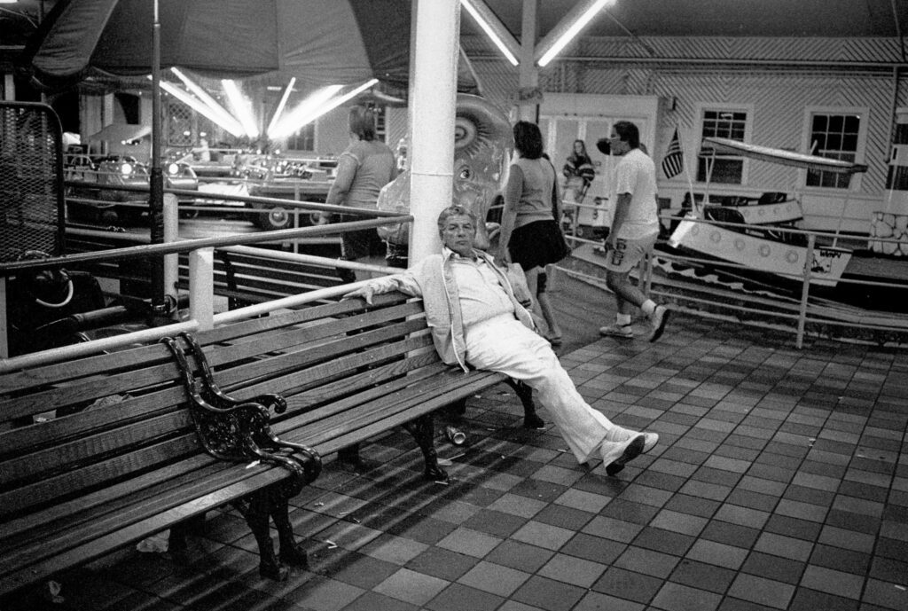 a woman sitting on a bench in a train station