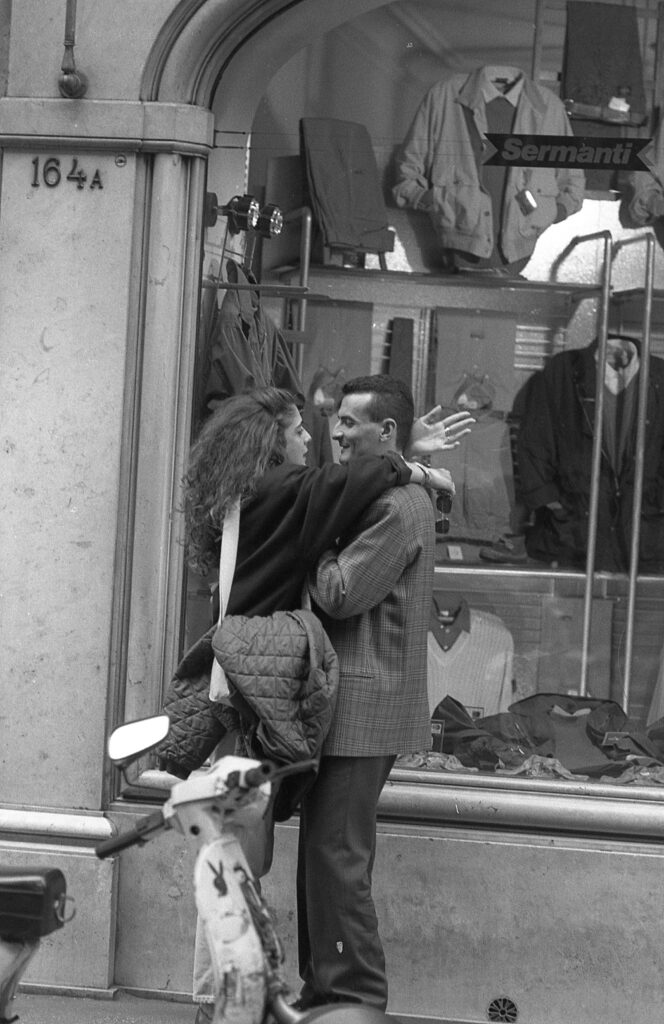 a man and woman standing next to each other in front of a store
