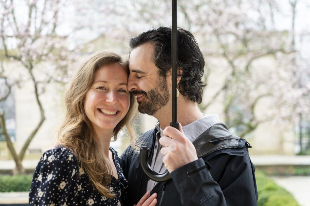 a man and woman standing under an umbrella