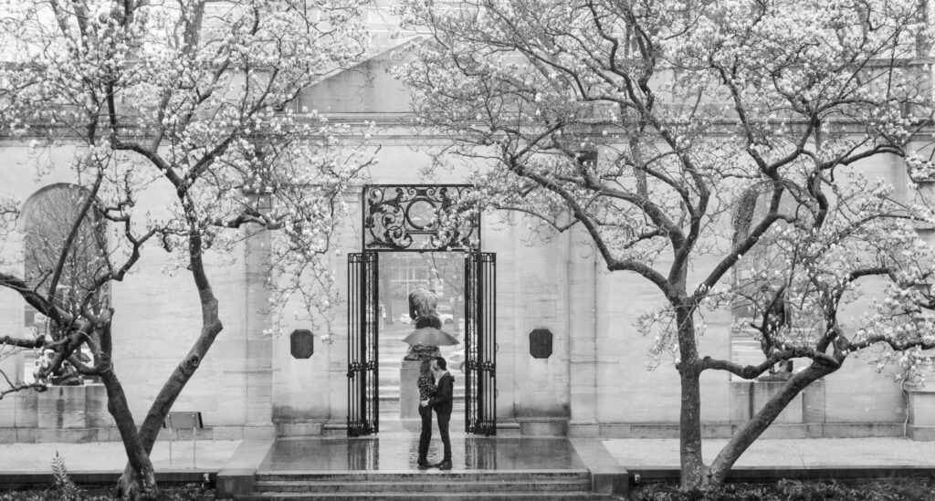 two people are standing in front of a building