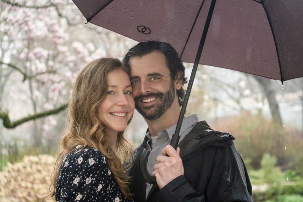 a man and woman standing under an umbrella