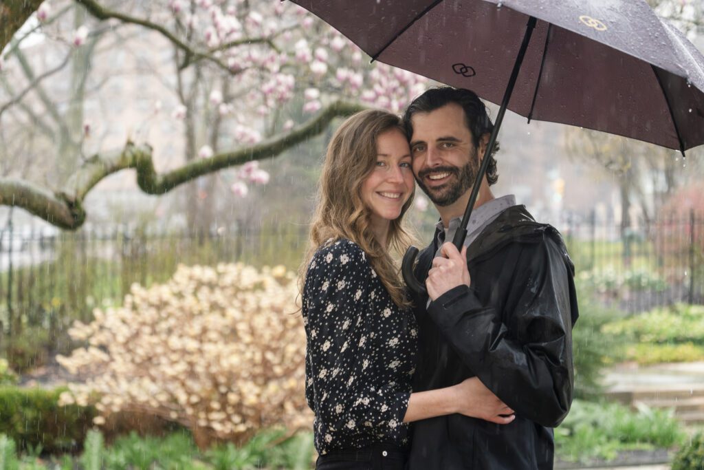 a man and woman standing under an umbrella