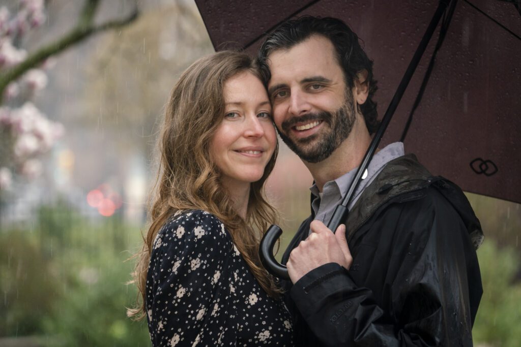 a man and woman standing under an umbrella