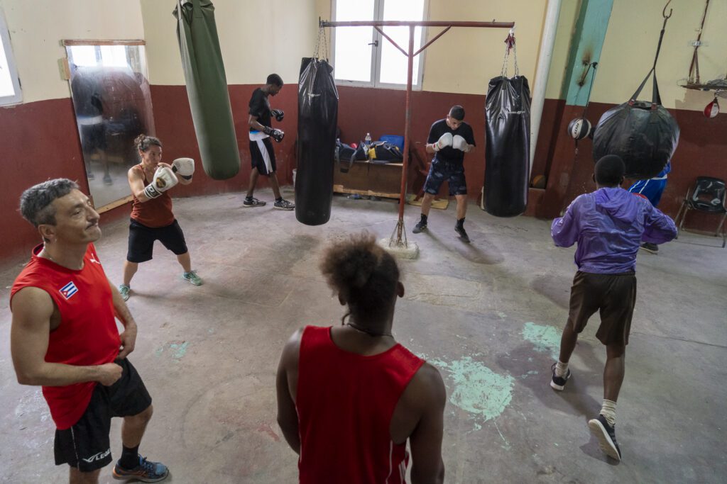 a group of people practicing boxing in a gym