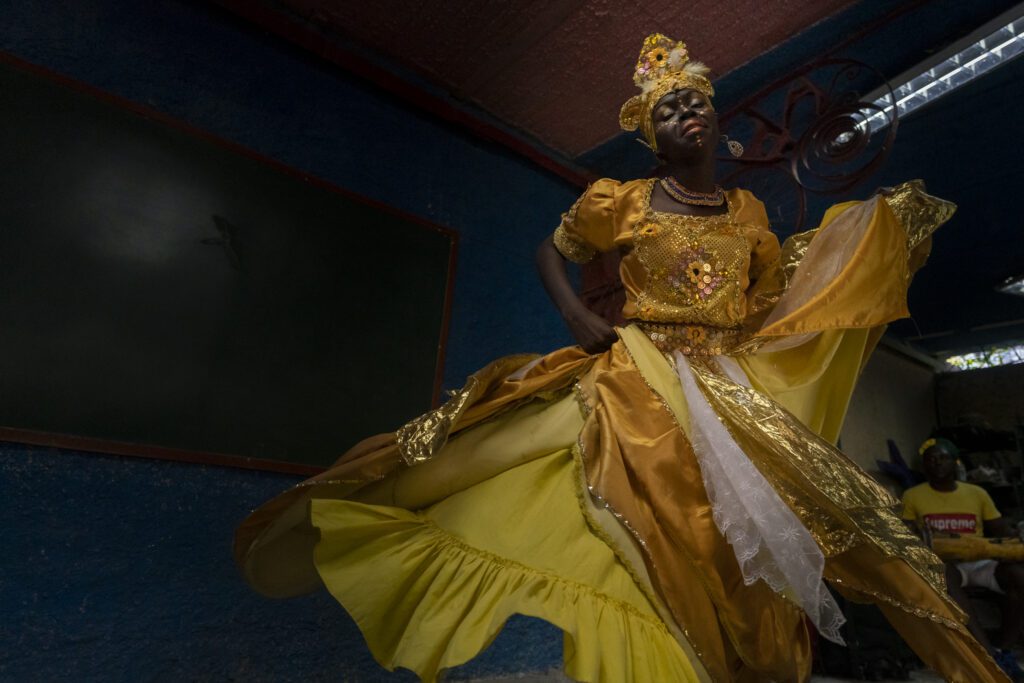 a woman in a yellow and gold dress